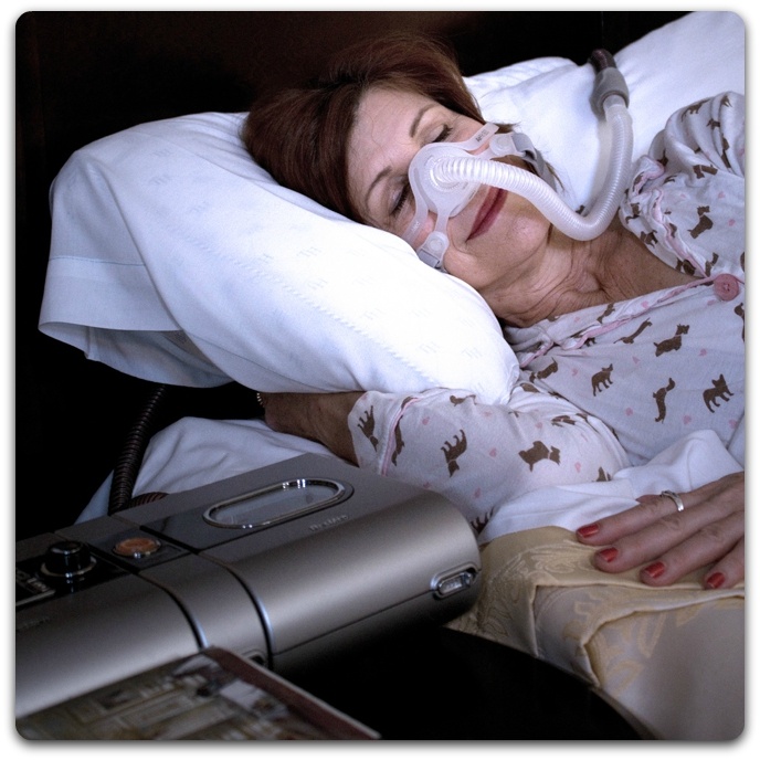 Woman sleeping soundly with PAP machine
